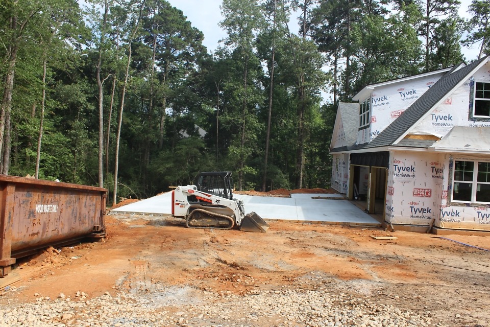 Concrete driveway and parking pad. 